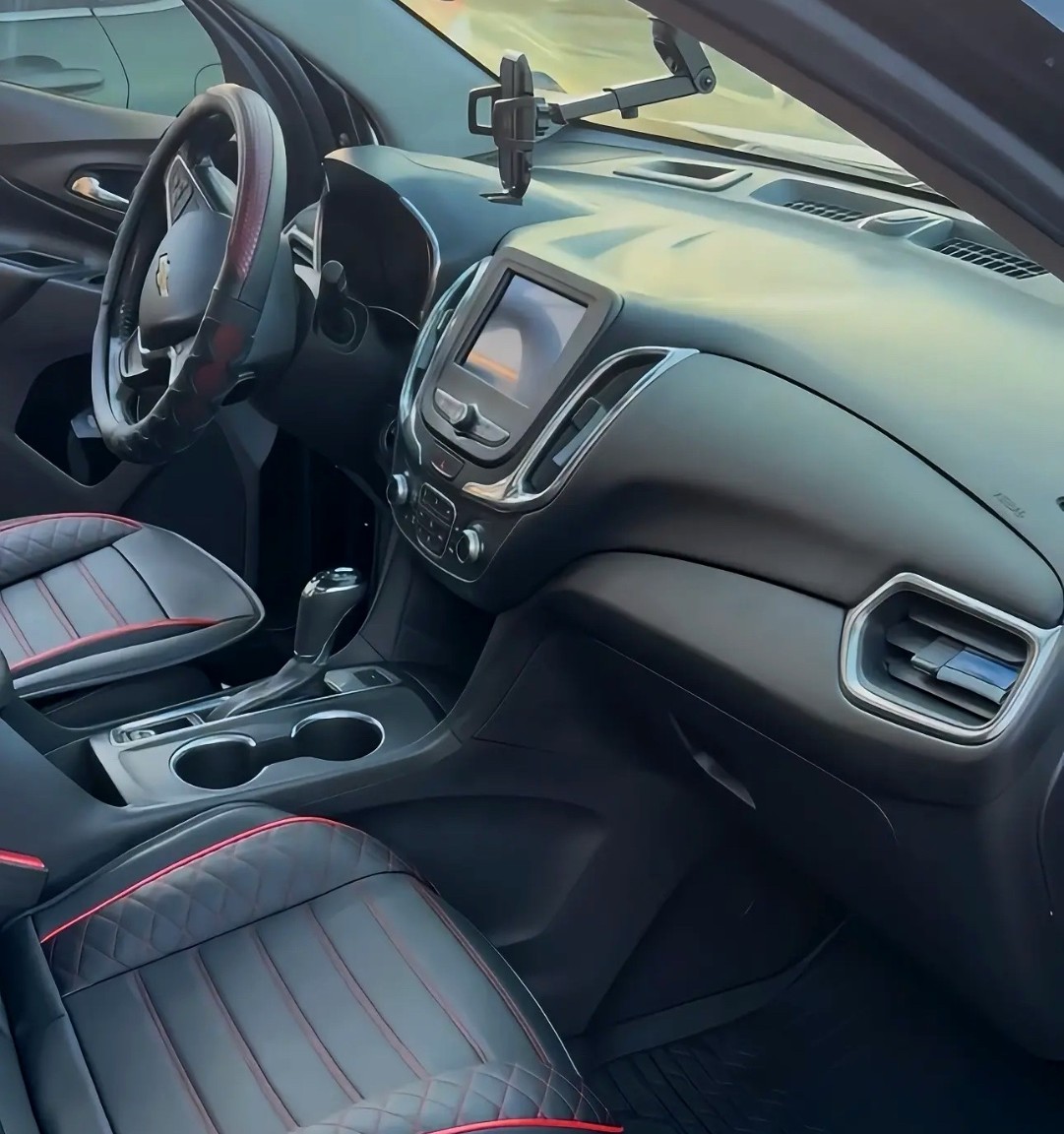 Detailed interior of a Chevrolet with custom red-stitched black leather seats